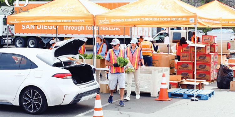 Volunteers distribute rescued produce at a food distribution in chula vista