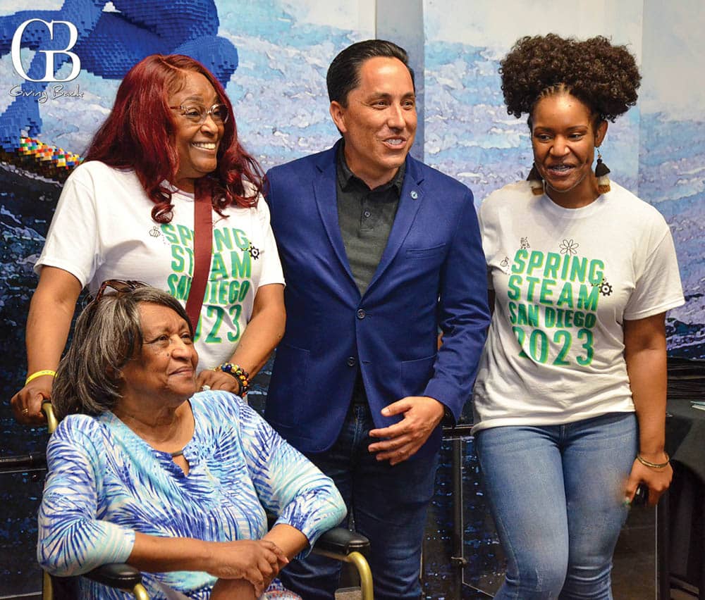 Mayor Todd Gloria poses with volunteers at the Spring STEAM Resource and Career Fair an event co created by the Fleet and Blac