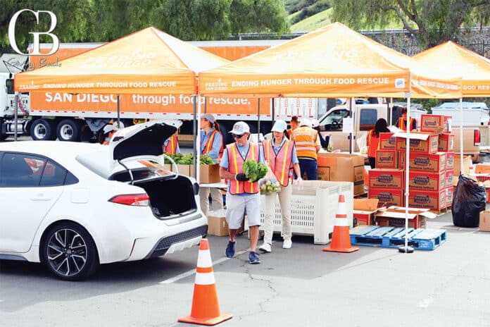 Volunteers distribute rescued produce at a food distribution in Chula Vista