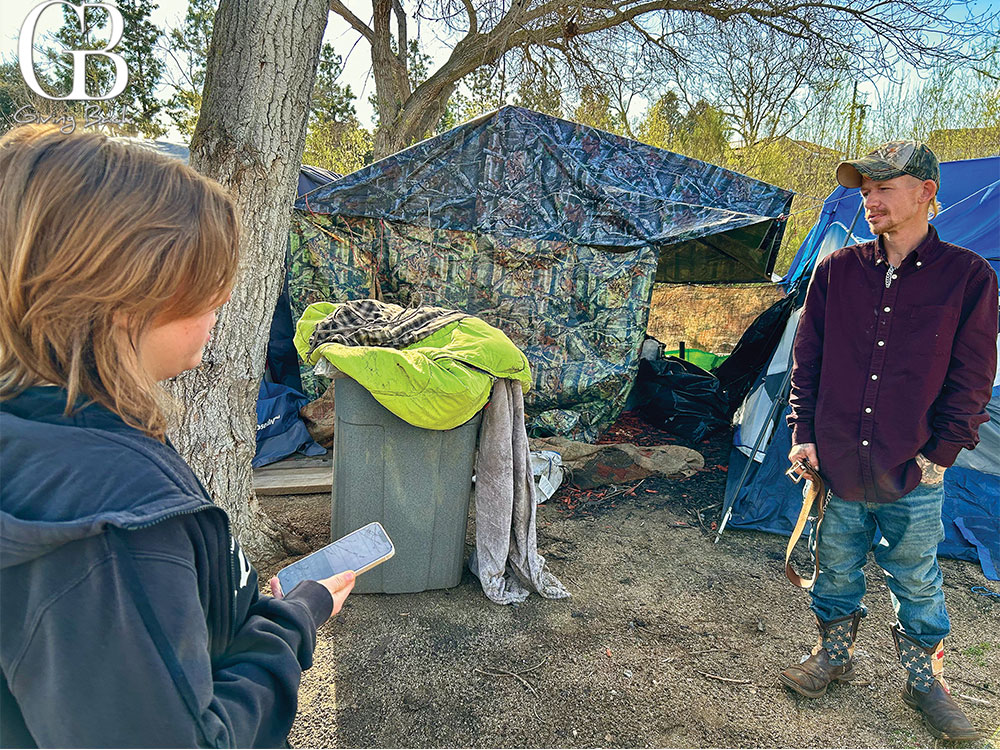Intern surveying person at an encampment