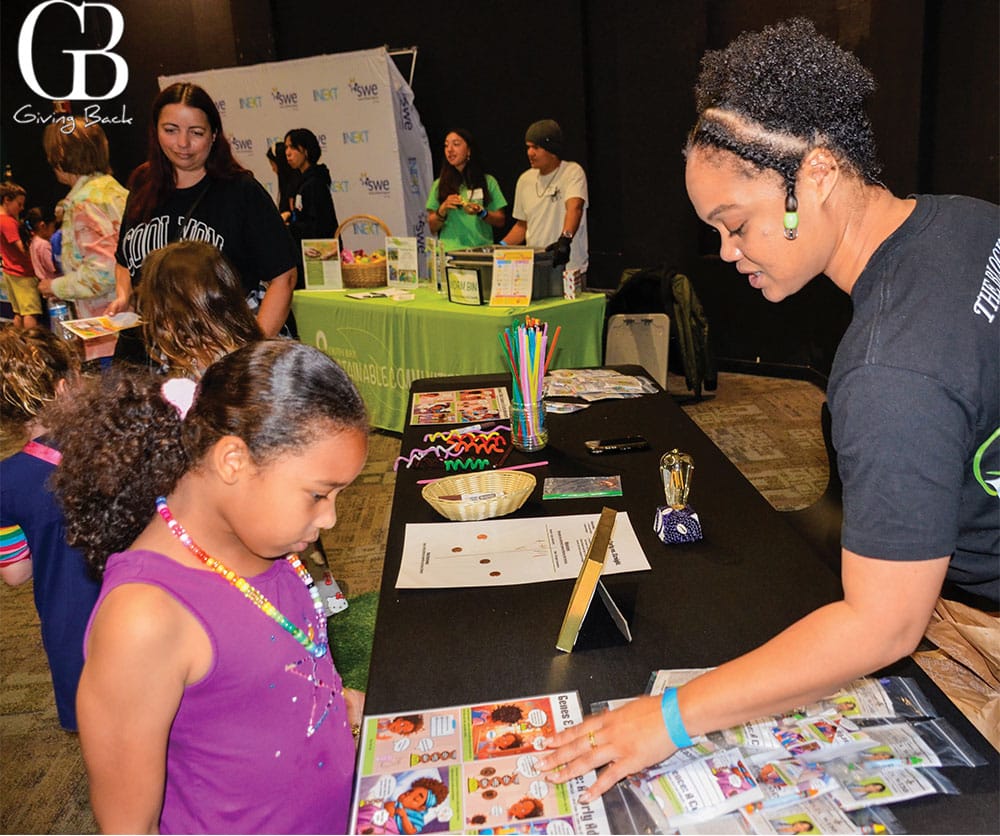 Little girl reads comic strips about curly hair