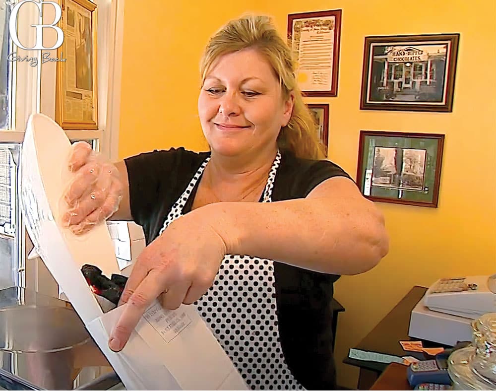 Owner Dana Eacobellis serves up some freshly made goodies for a customer at Wisteria Candy Shop