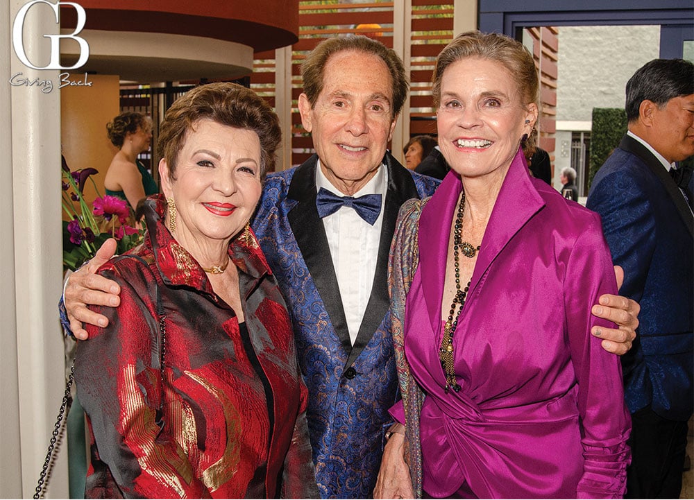 Diana and Eli Lombrozo with Diana Lady Dougan'GB Giving Back' logo in the corner.