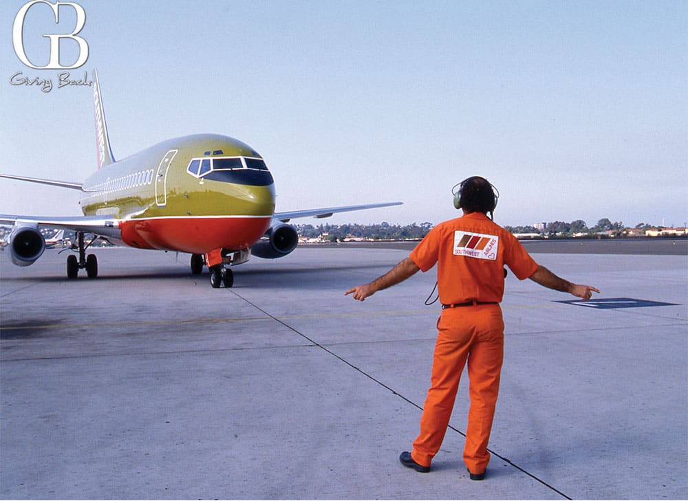 A-Southwest-Airlines-ramp-agent-welcomes-in-a-Southwest-aircraft-to-San-Diego-in-1982 - GB Magazine A Southwest Airlines ramp agent welcomes in a Southwest aircraft to San Diego in 1982