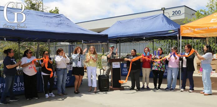 Alicia Kitagawa from Life Science Cares, with Bob Kamensky from Feeding San Diego, with team members at the Encanto Food Pantry Ribbon Cutting