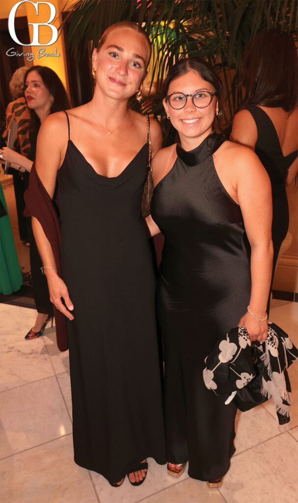 Elena-Miralles-and-Cecilia-Calatroni - GB Magazine Elena Miralles and Cecilia Calatroni'Giving Back' logo in the background.
