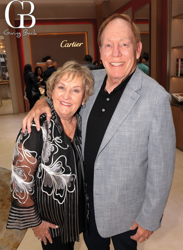 John and Linda Wilson'Giving Back' logo in the corner; man has his arm around the woman.