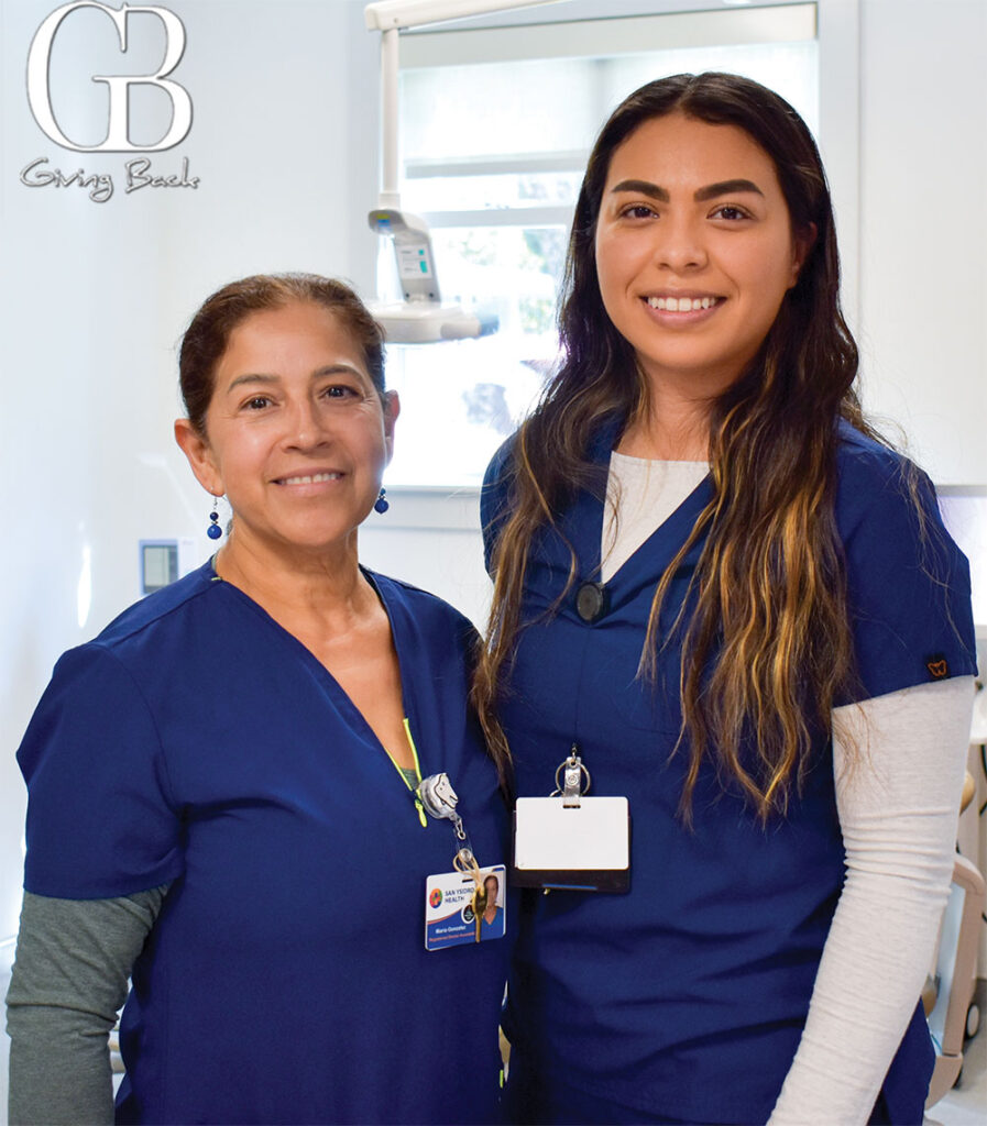 Maria-Gonzalez-and-Alejandra-Ortiz - GB Magazine Maria Gonzalez and Alejandra Ortiz'Giving Back' logo in the top left.