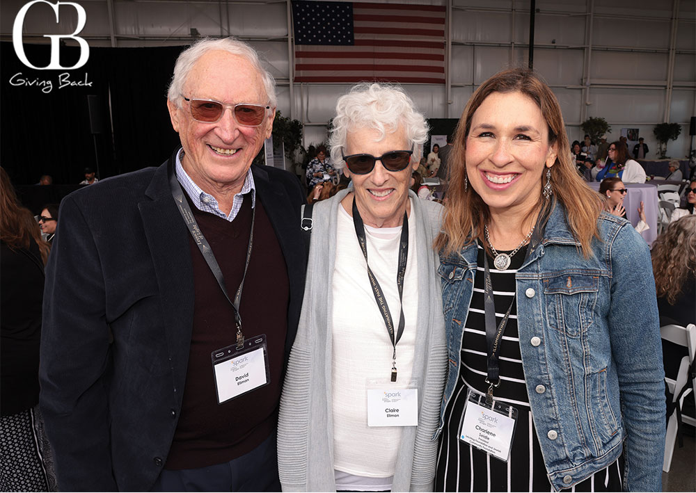 David-and-Claire-Ellman-with-Charlene-Seidle - GB Magazine David and Claire Ellman with Charlene Seidle'Giving Back' logo in the corner (GB).